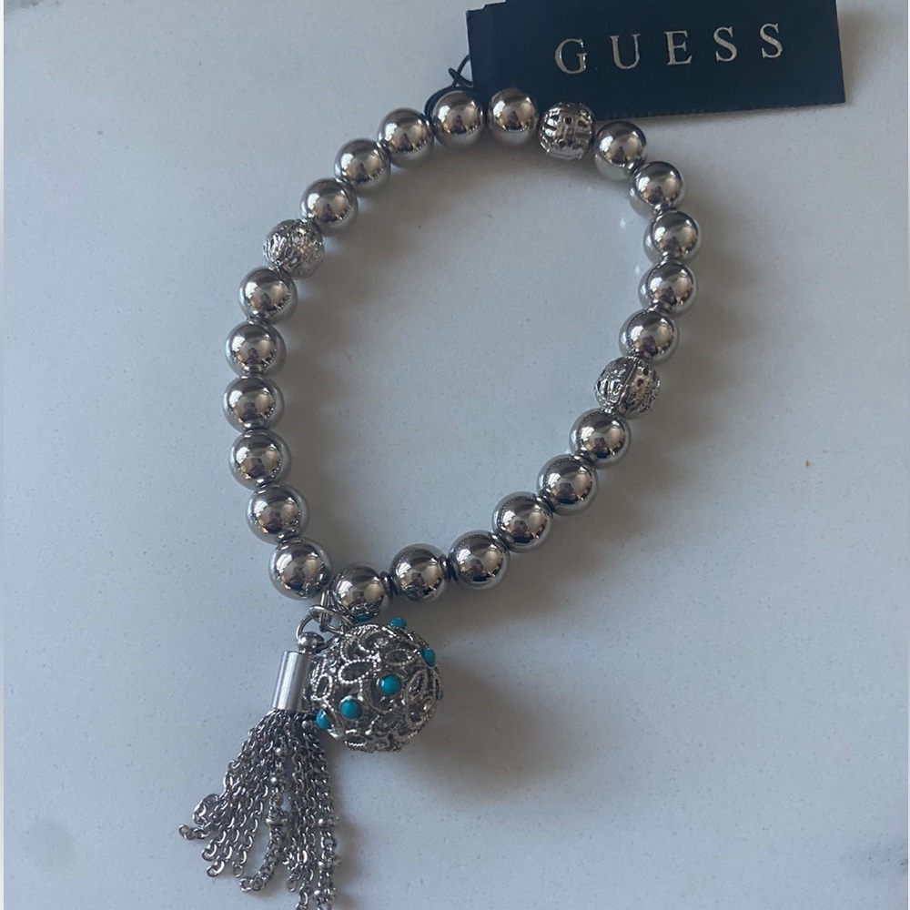 NWT Guess Silvertone Beaded Strech Bracelet with Tassle and Ball Charms